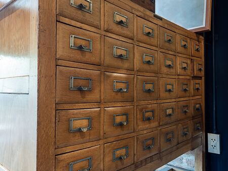 Old vintage wooden library card catalog cabinets in Library room.の写真素材