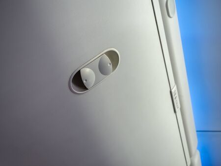 Close-up hand luggage compartment in cabin economy class on the low cost commercial airplane.