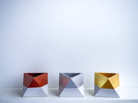Cactus pot. Concrete pot. Gold, silver and copper painted geometric concrete planters on white shelf...
