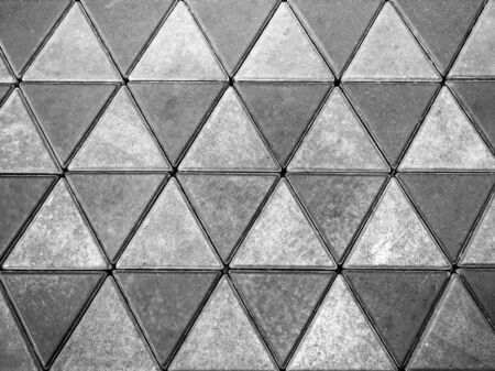 Grey concrete floor, triangle pattern background. Cement tiles floor texture.