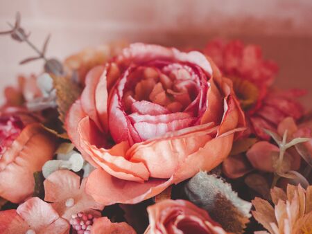 Beautiful flower bouquet vintage style. Close-up artificial red or pink roses.の写真素材