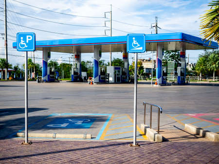 CHAIYAPHUM, THAILAND - May 31, 2020: Disabled parking sign in gas station. Wheelchair ramp way with...