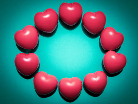 Pink hearts on light green background with copy space with vivid retro colour style. Wreath made...