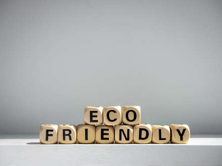 Eco friendly words on wooden cube on white background with copy space.