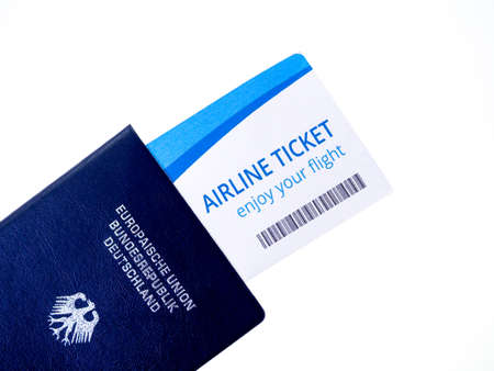 Passport and airline boarding pass ticket isolated on white background. Blue passport of Germany,...