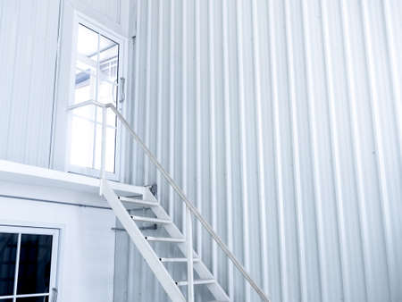 Inside white modern cutting-edge shipping container construction office building with white iron...