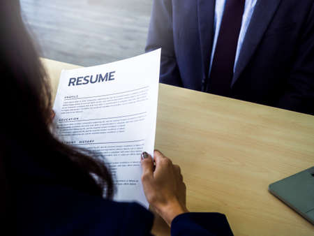 Resume or CV paper in employer 's hand and review the applicant profile. Businesswoman, HR reading...