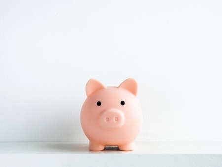 Cute piggy bank, pink color, front view isolated on white background with copy space. Saving money,...