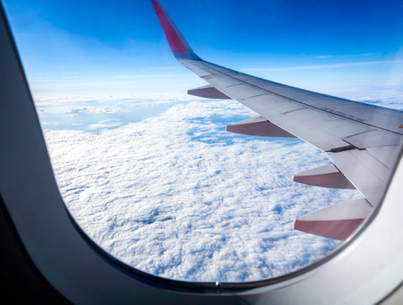 Above the cloud, amazing sky with airplane wing, view from airplane window. Beautiful cloudscape...