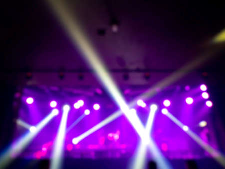 Blurred stage light concert background with colorful beam and laser rays on stage. Defocused entertainment show lighting.の写真素材