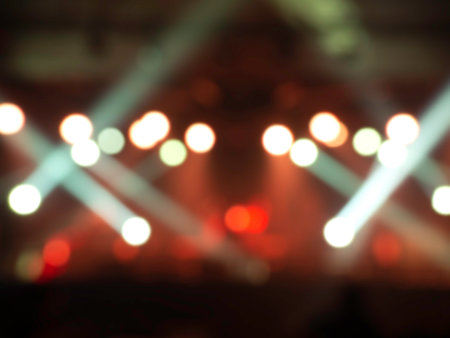 Blurred stage light concert background with colorful beam and laser rays on stage. Defocused entertainment show lighting.の写真素材