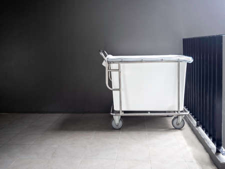 Empty hotel housekeeping maid laundry trolley without bed sheets, pillowcases and towels from guest in the hotel with copy space.の写真素材
