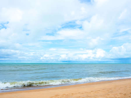 Summer seascape background. Beach sand and sea on blue sky and clouds background.の写真素材
