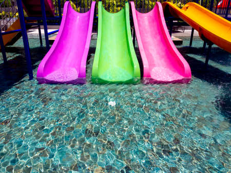 Colorful fun water slider in the pool with clear and clean water.の写真素材