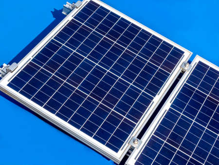 Close up solar panel on blue boat roof background. Solar panel isolated on blue background.の写真素材