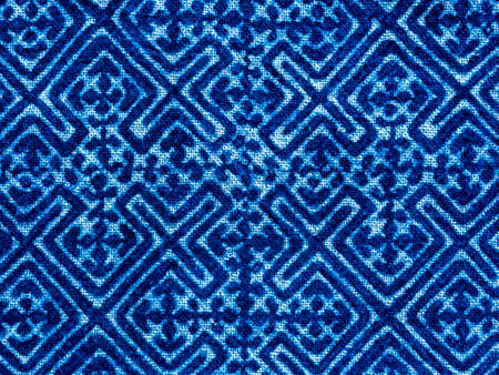 Indigo blue fabric tie dye pattern background. Indigo-Dyed fabric texture with abstract ethnic graphic motif pattern.の写真素材