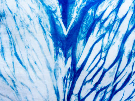 Indigo blue fabric tie dye pattern background. Indigo-Dyed fabric texture with abstract ethnic...
