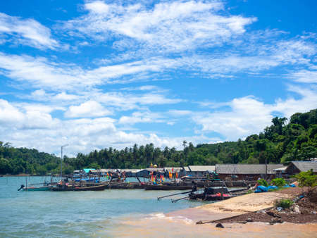 Beautiful seascape summer background. Scene of fisherman village with many local longtail boat on the sea and sky background on a sunny day in Thailand.の写真素材
