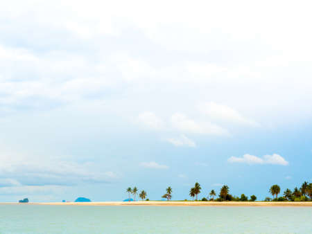Beautiful seascape summer background minimal style with many palm trees on sand beach, sea and the vast sky background on a sunny day at Koh Yao Yai in Thailand.の写真素材