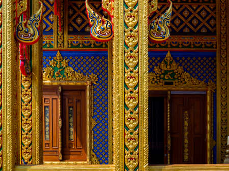 FEBRUARY 15, 2021: NAKHON SAWAN, THAILAND. The beautiful exterior temple building, church door and wall with traditional colorful of Thai art stucco, bas-relief at Wat Makkah Rangsarit (Wat Takro).のeditorial素材