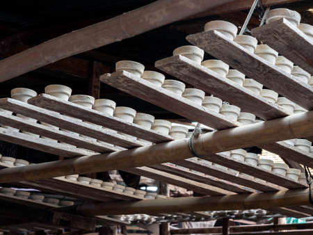 Many small plates, round shape made by ceramic clay and dried with sunshine. Earthenware process...
