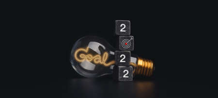 2022 Happy New year banner with goal and success concept. The 2022 numbers on black dice stack, target icon and light bulb with neon light style words on dark background, modern and minimal style.の写真素材