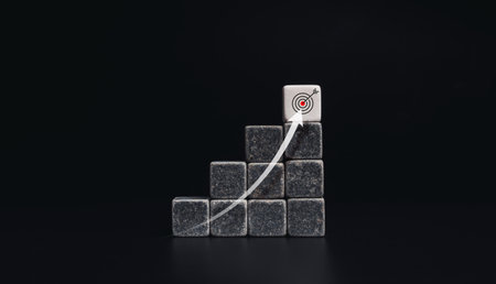 Risingup arrow from below to the top on chart steps with black and white dice blocks with target...