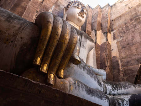 Closeup huge hand of ancient buddha statue inside the church at Wat Sri Chum Temple, the famous landmark in at Sukhothai Historical Park, a UNESCO World Heritage Site in Thailand.のeditorial素材