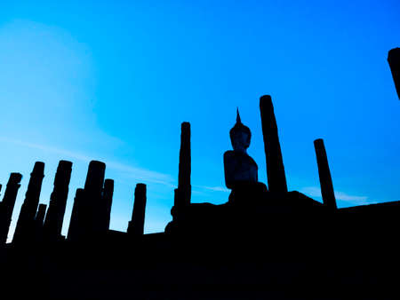 Amazing scenetic of silhouette of Wat Mahathat Temple in the precinct of Sukhothai Historical Park with big buddha statue on blue sky background, a UNESCO World Heritage Site in Thailand.のeditorial素材