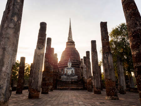 Amazing scene of big buddha statue and old ancient ruins at Wat Mahathat Temple in the precinct of Sukhothai Historical Park, a UNESCO World Heritage Site in Thailand.のeditorial素材
