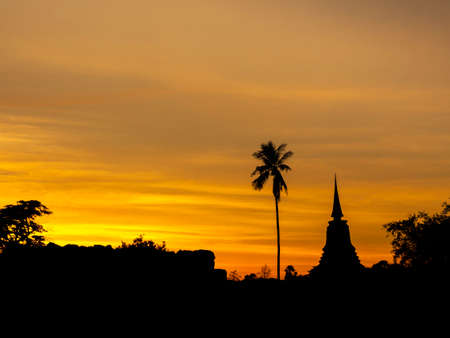 Amazing scenetic of silhouette of pagoda, temple and gold sunset sky in Sukhothai Historical Park, a UNESCO World Heritage Site in Thailand.のeditorial素材