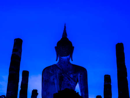 Amazing scenetic of silhouette of Wat Mahathat Temple in the precinct of Sukhothai Historical Park with big buddha statue on blue sunset sky background, a UNESCO World Heritage Site in Thailand.のeditorial素材