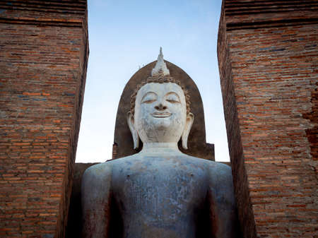 Amazing scene of big standing buddha statue and old ancient constructure at Wat Mahathat Temple in the precinct of Sukhothai Historical Park, a UNESCO World Heritage Site in Thailand.のeditorial素材