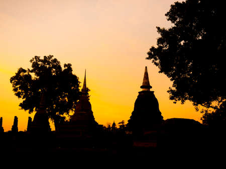 Amazing scenetic of silhouette of pagoda, temple and gold sunset sky in Sukhothai Historical Park, a UNESCO World Heritage Site in Thailand.のeditorial素材