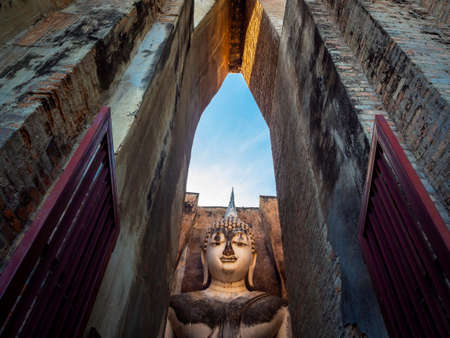 Amazing scene of ancient big buddha statue inside the old church at Wat Sri Chum Temple, the famous landmark in at Sukhothai Historical Park, a UNESCO World Heritage Site in Thailand.のeditorial素材