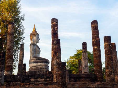 Amazing scene of big buddha statue and old ancient ruins at Wat Mahathat Temple in the precinct of Sukhothai Historical Park, a UNESCO World Heritage Site in Thailand.のeditorial素材