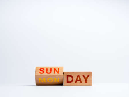 Changing to the first working day of the week. Flipping wooden cube blocks for change words, days...
