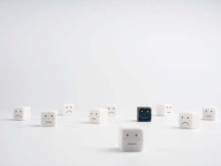 Black dice with smile face standing out from crowd, white dice with weak emotion, white background. Unique, individuality and difference concept. Individuality, independence, leadership, trendsetter.の写真素材