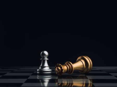 A little silver pawn chess piece standing with the win near a fallen golden queen chess piece on a chessboard on dark background. Leadership, winner, brave, competition, and business strategy concept.の写真素材
