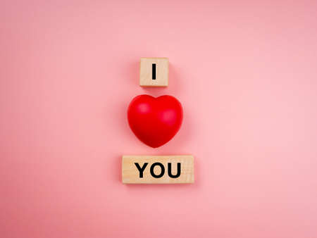 I love you, text on wooden cube block and red heart balloon on pink pastel background. Love concept minimal style.の写真素材