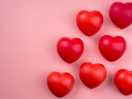 Group of red heart ball on pink pastel background with copy space. Love, care, sharing, giving, well-being, and donation concepts, minimal style.の写真素材