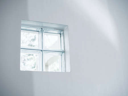 Close up four glass blocks, window bricks, lighted channel for the light through on the white wall...