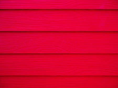 Red wood texture, wall background surface with a horizontal pattern. Vivid red timber table top view.の写真素材
