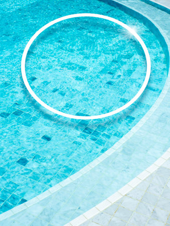 A round shape of a white line makes a decorated circle frame on the swimming pool background, vertical style. Empty blank space border frame for summer, vacation time, holiday concept.の写真素材