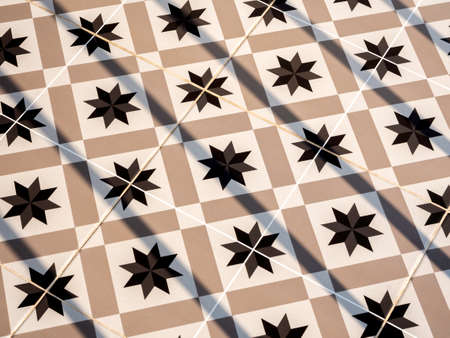 Vintage tile floor pattern with black, white and beige colors. Geometric pattern ceramic mosaic background with light and shadow.の写真素材