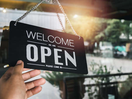Open sign board with white text on black vintage wooden sign Welcome we are open please come in...