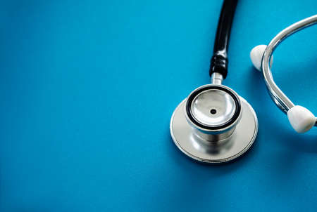 Close up stethoscope isolated on blue background with copy space, top view. Healthcare and medical concept.の写真素材