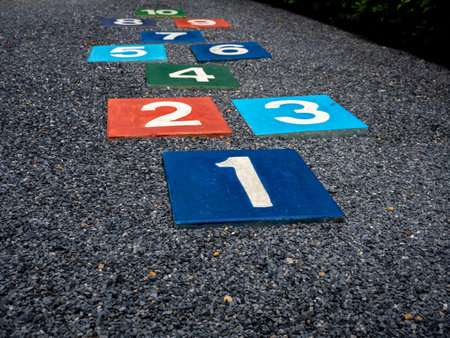 Number 1 on multicolored hopscotch on the asphalt ground in the kids playground with nobody, outdoors game activities for children. Growth and education concept.の写真素材