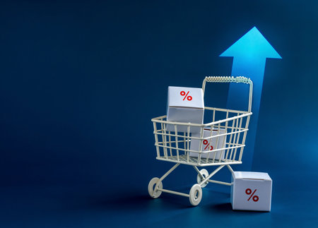 Inflation, increase sales, rising up price, business marketing concepts.  Red percentage icon on parcel boxes in white shopping cart trolley with rising arrows on blue background with copy space.の写真素材