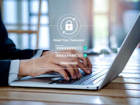 Reset password concept. Lock icon, security code showing on change password page while business person using laptop computer in office. Cyber security technology on website or app for data protection.の写真素材